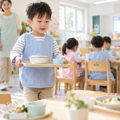 雙手拿穩餐盤，一步一步把午餐帶到座位。